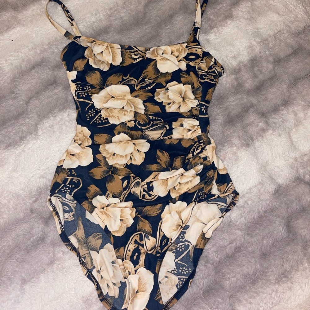 Beautiful teal color background with cream colored florals swimsuit very classy